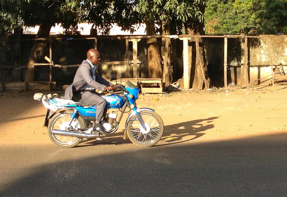 Dobře oblečený Nigerijec ve městě Kaduna na své modré motorce - Cestovinky.cz