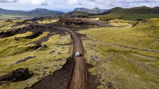 Automobil jedoucí po štěrkové cestě