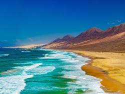 Divoká pláž s horami na západě ostrova